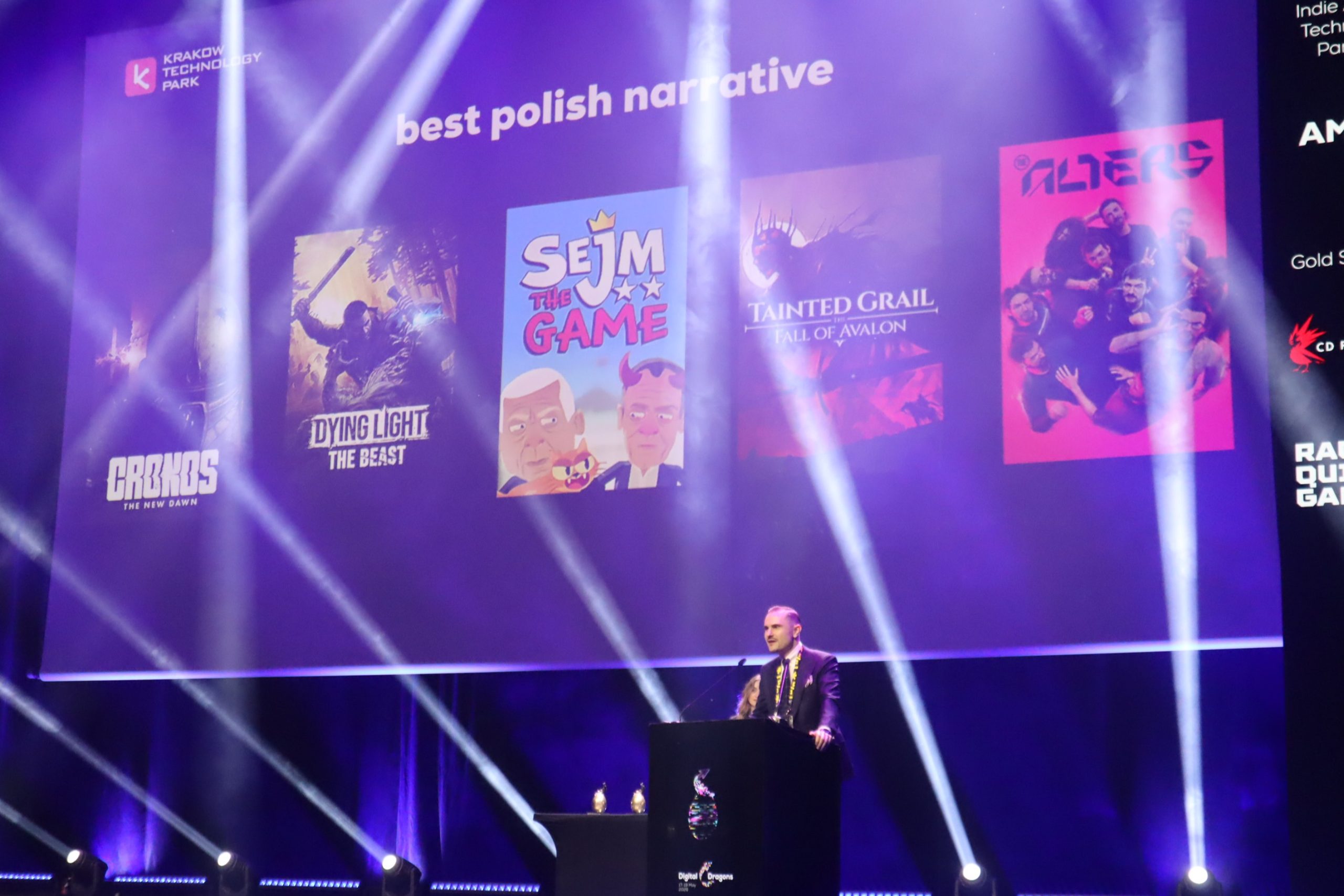 Stage with purple lighting and game posters (Sejm the Game, Dying Light: The Beast) as a presenter speaks at a podium.