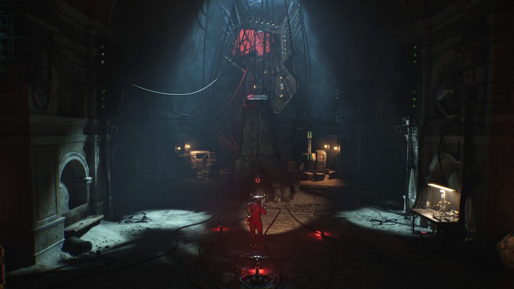 A person in a red suit stands in a dim industrial chamber, facing a giant machine with cables overhead and a blue glow above.