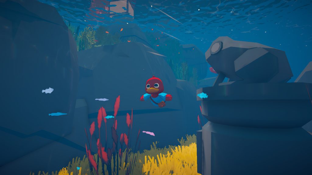 Cartoon red penguin in a blue shirt swimming underwater among rocks and colorful coral.
